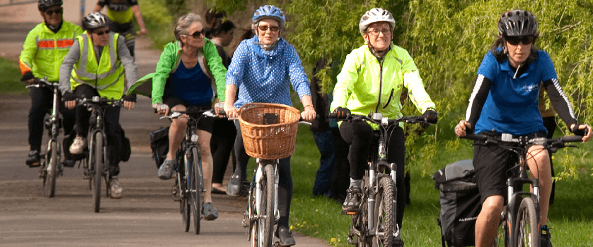 A group of older cyclists riding together