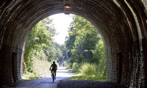 Cyclist riding through a tunnel along the Bristol to bath railway path