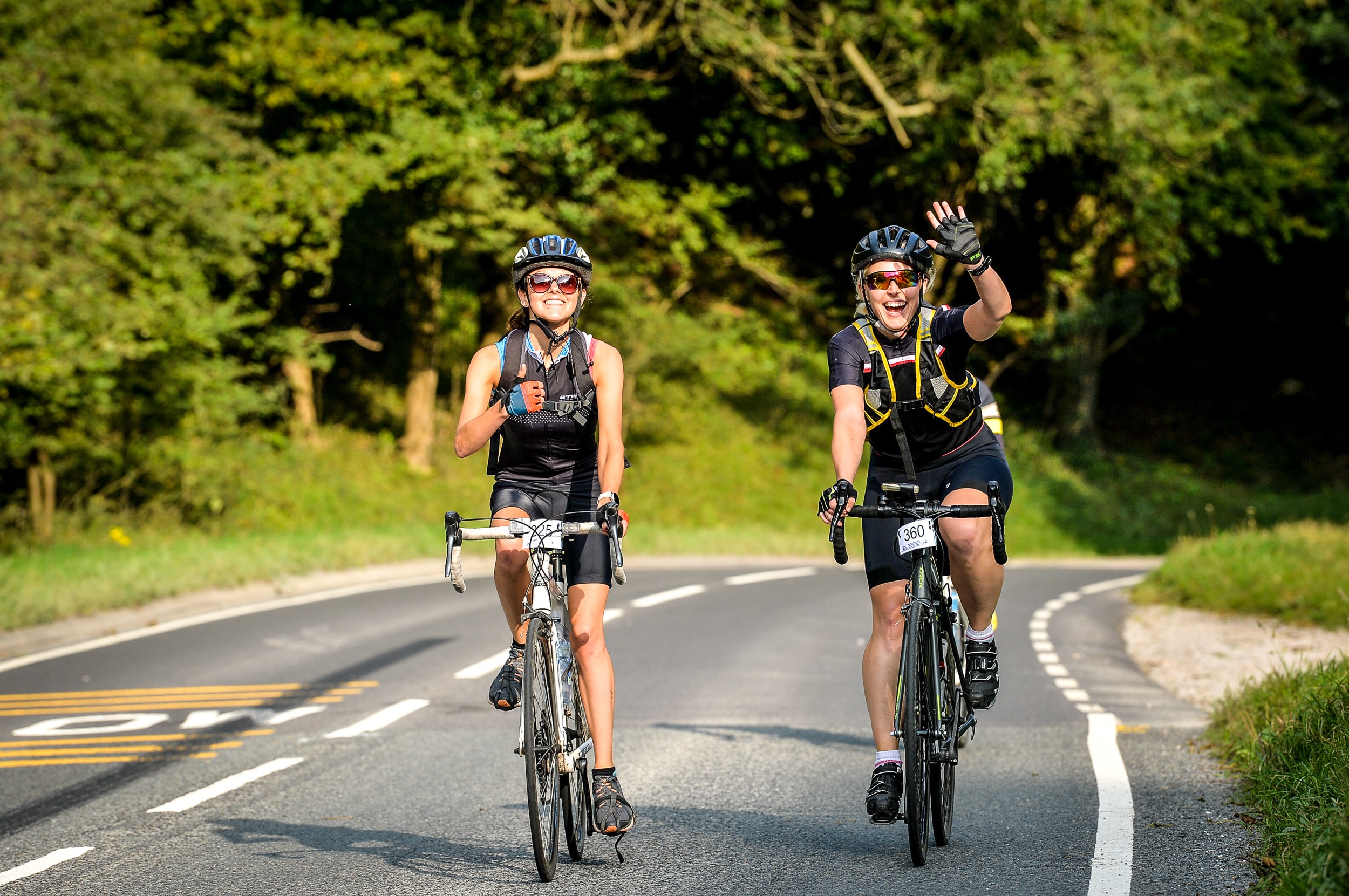 Two women riding a bike taking part in great weston ride
