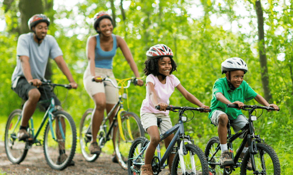 Image of family cycling together