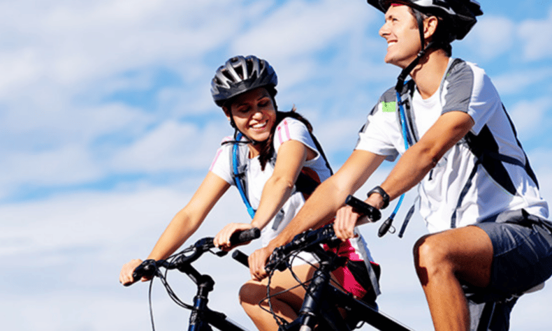 Man and women cycling together